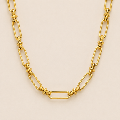 Gold paperclip-link chain necklace, the Iris NECKLACE, featuring elongated oval links joined by small round connectors, shown in close-up.
