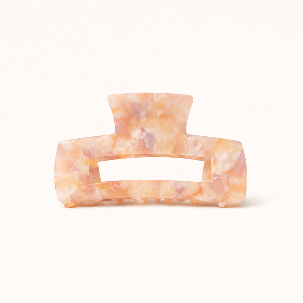 Peach and tan pearl marbled rectangular acetate claw clip with a cutout handle from the It Girl Big HAIR CLIP collection.