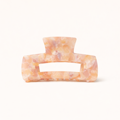 Peach and tan pearl marbled rectangular acetate claw clip with a cutout handle from the It Girl Big HAIR CLIP collection.