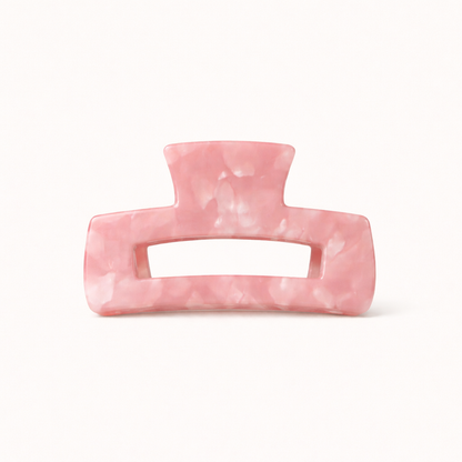 Solid pink marbled rectangular acetate claw clip with a cutout handle from the It Girl Big HAIR CLIP collection.