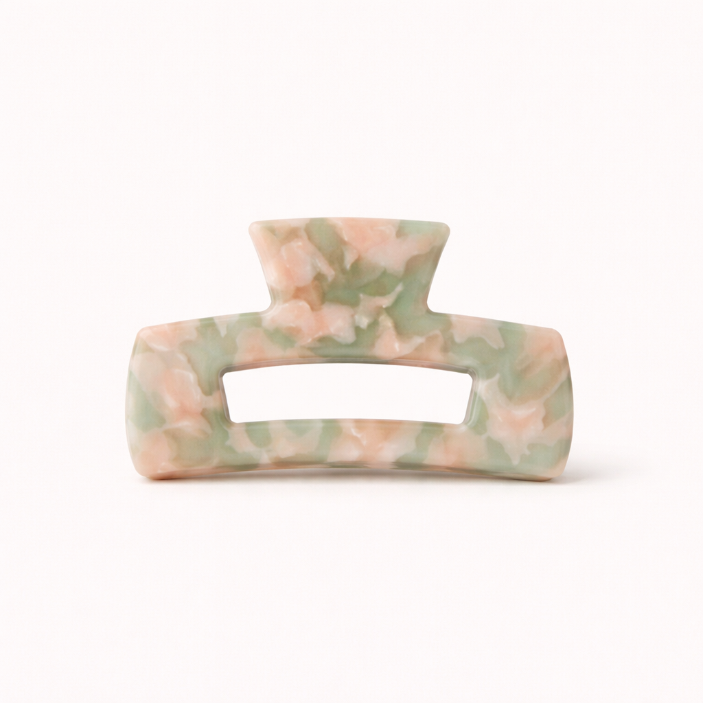 Pink and sage green marbled rectangular acetate claw clip with a cutout handle from the It Girl Big HAIR CLIP collection.