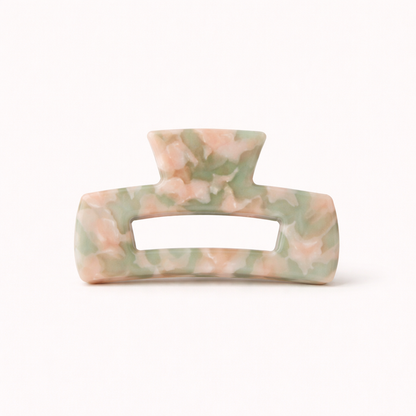 Pink and sage green marbled rectangular acetate claw clip with a cutout handle from the It Girl Big HAIR CLIP collection.