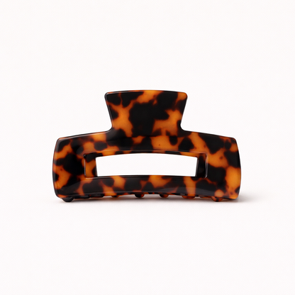 Amber and black tortoiseshell rectangular acetate claw clip with a cutout handle from the It Girl Big HAIR CLIP collection.
