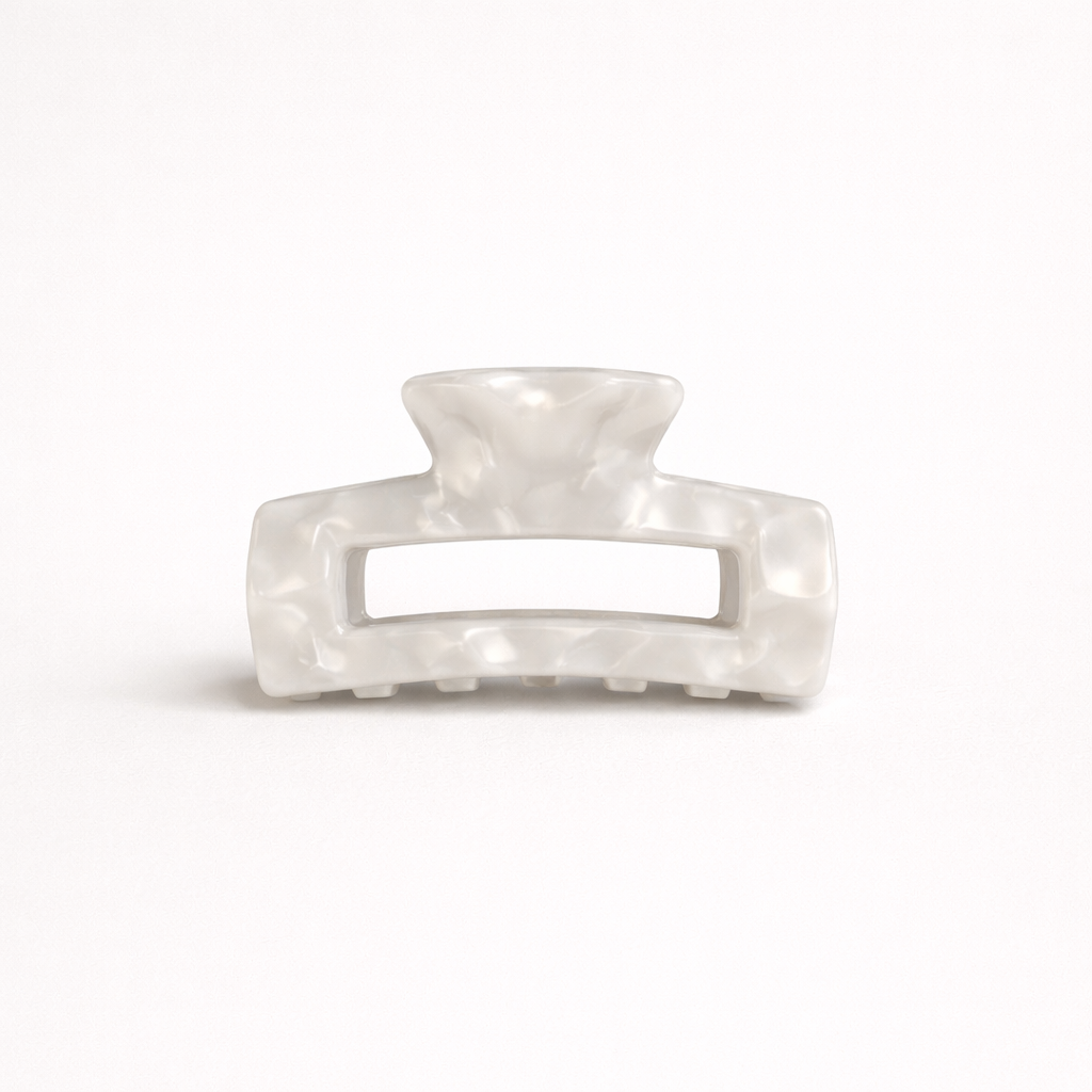 White pearl marbled rectangular acetate claw clip with a cutout handle from the It Girl Medium HAIR CLIP collection.