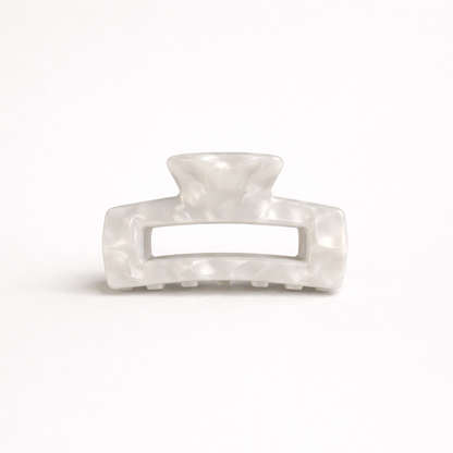White pearl marbled rectangular acetate claw clip with a cutout handle from the It Girl Medium HAIR CLIP collection.