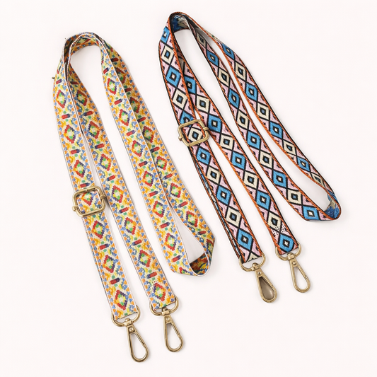 Two Jetlag long phone strap colorways shown together: a multicolor print and a blue-and-pink Aztec pattern.
