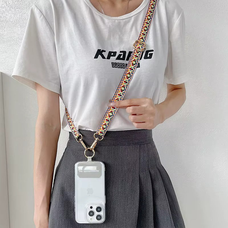 Model wears a multicolor woven Jetlag strap crossbody with a white phone case clipped at the hip.