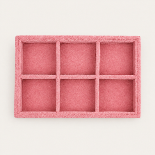 Small pink velvet jewelry tray with six square compartments for organizing earrings and small accessories.