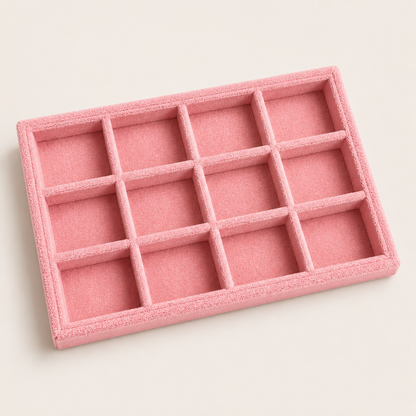 Medium pink velvet jewelry tray with twelve square compartments, shown at an angle for organizing rings and jewelry.