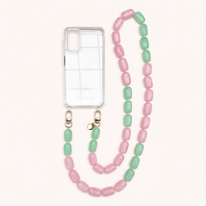 A clear phone case with a pink and mint green bead phone chain, shown on a cream background.