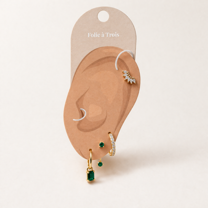 Juna Set displayed on a Folie a Trois ear-shaped card, arranging the crawler stud, pave hoop, and emerald pieces for styling.