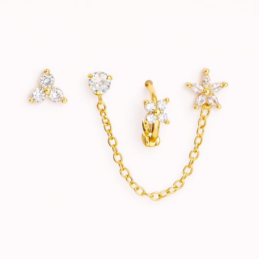 The Juno SET includes four gold pieces: a trio stud, a chain-linked stud, a flower huggie, and a star drop.