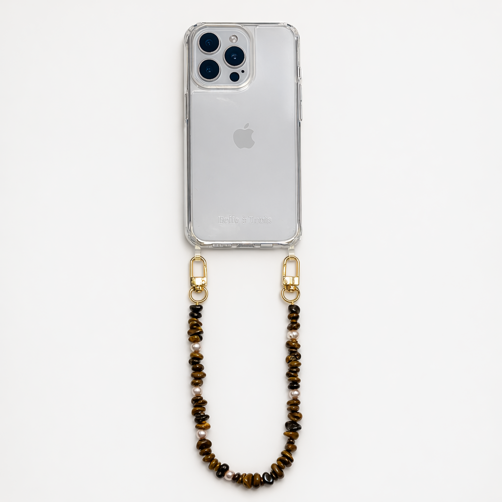 Brown and gold chip-bead Lagoon Stones SHORT PHONE STRAP attached to a clear phone case, shown as a flat lay.