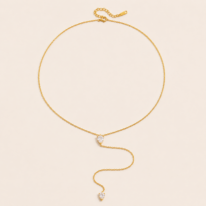 Gold Lariat Y NECKLACE with two pear-shaped crystal accents on a fine chain, drawn into a long drop, laid flat.