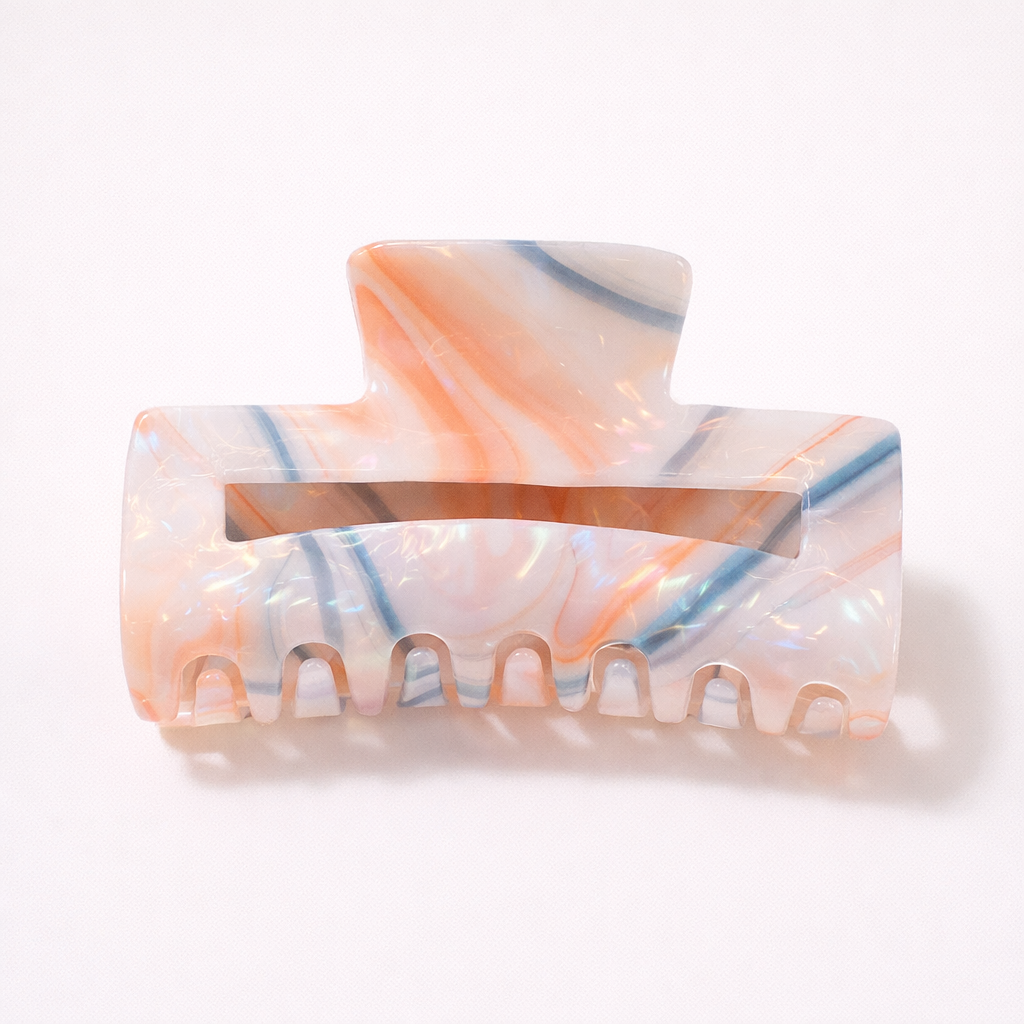 Lark HAIR CLIP large rectangular acetate claw clip in white with orange and blue streaks, studio shot.