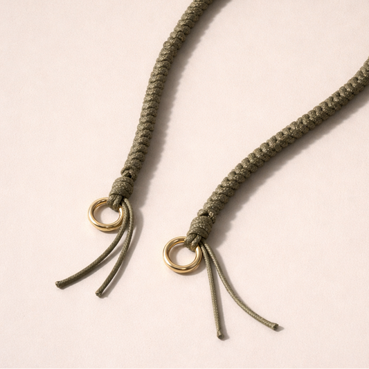 Olive green braided Layover long phone strap, close-up of the knotted gold ring and fringe end.