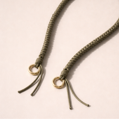 Olive green braided Layover long phone strap, detail view of the gold ring and fringe end.
