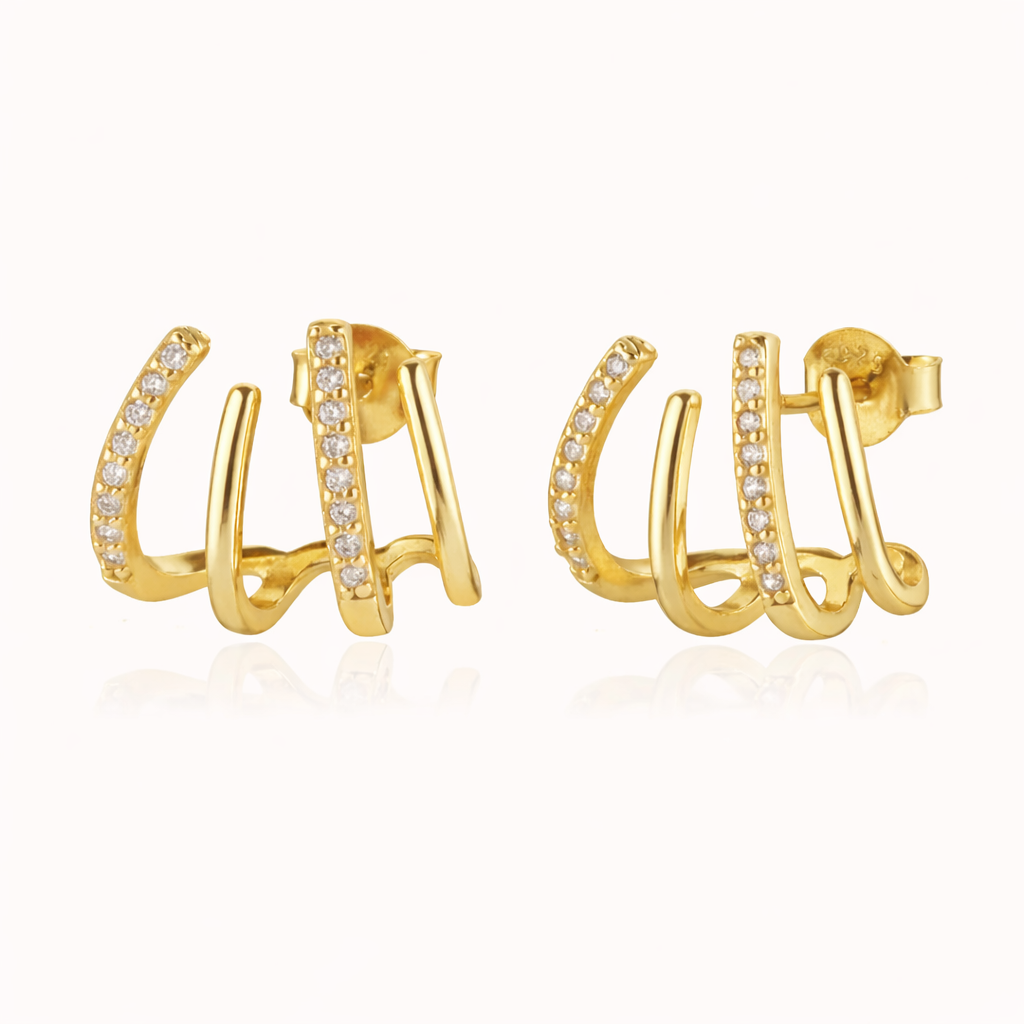 The Lennon EARRINGS are gold triple-band studs, one pave-lined, curving upward for a sculptural stacked look.