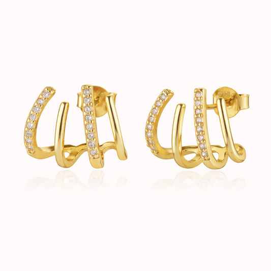 The Lennon EARRINGS are gold triple-band studs, one pave-lined, curving upward for a sculptural stacked look.