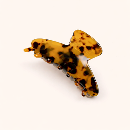 Amber and black tortoiseshell leaf-shaped acetate claw clip from the Let's Fall HAIR CLIP collection.