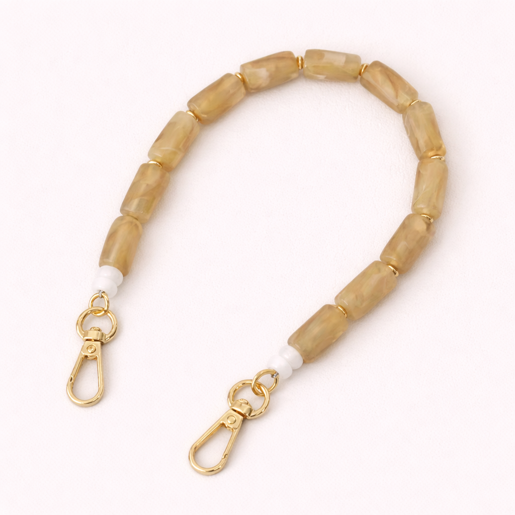 Tan and cream beaded Lilette short phone strap coiled flat with gold-tone clasp ends.