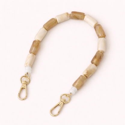 Tan and cream marbled beaded Lilette short phone strap coiled flat with gold-tone clasps.
