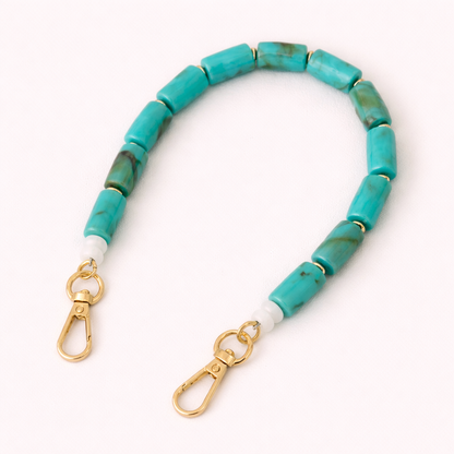 Turquoise beaded Lilette short phone strap coiled flat with gold-tone clasp ends.