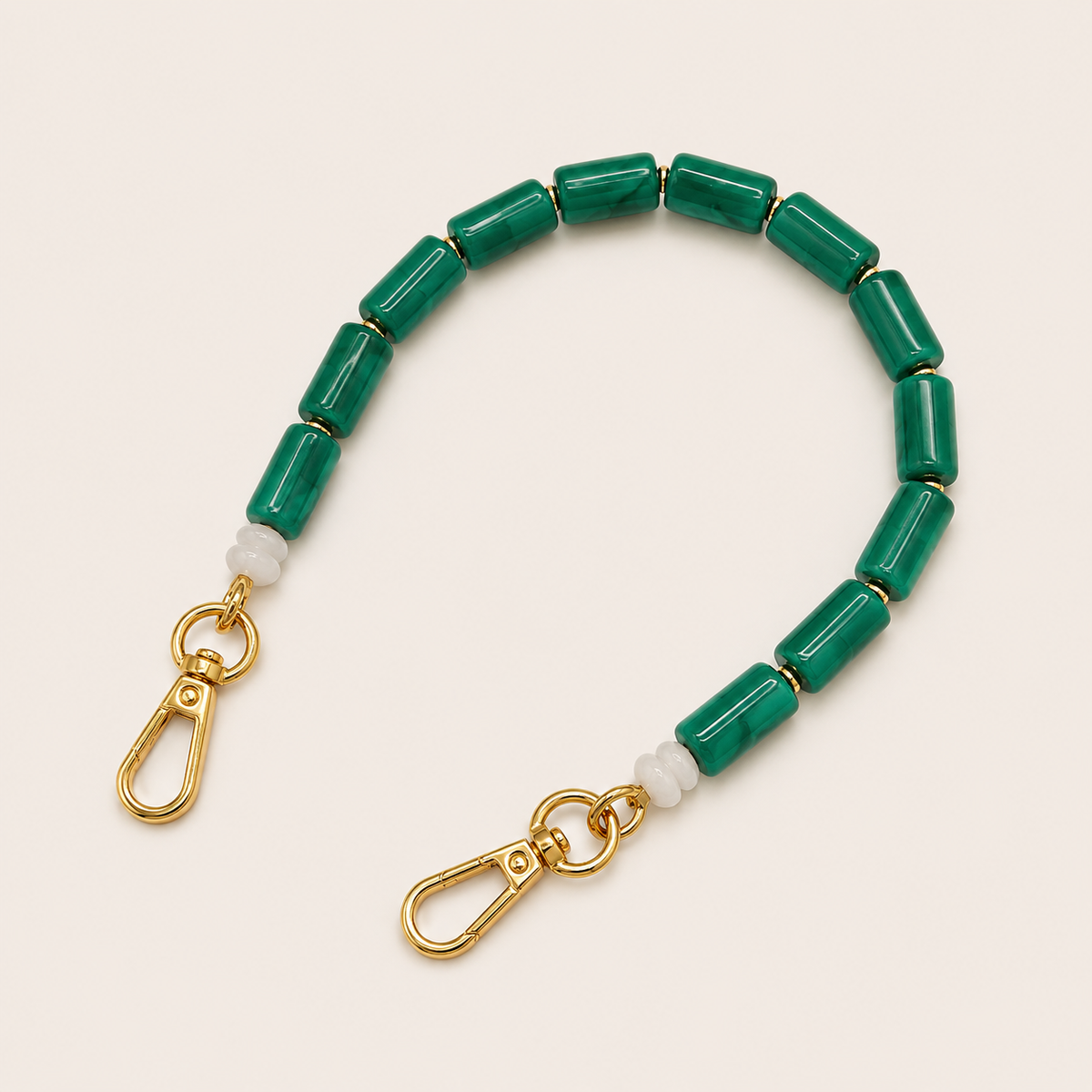 Solid green beaded Lilette short phone strap coiled flat with gold-tone clasp ends.