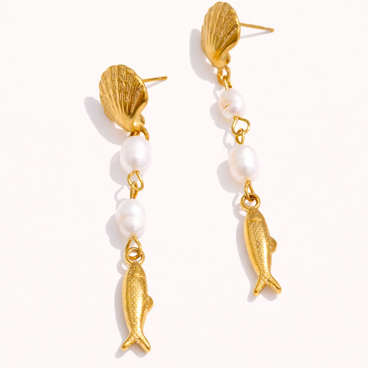 Lior Earrings pair a gold scallop-shell stud with two small pearl beads and a dangling textured gold fish charm below.