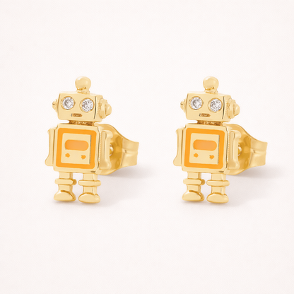 Little Robot Earrings appear here in orange enamel, their gold robot body topped with sparkling stone eyes.