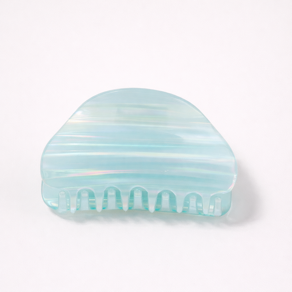 Livvy HAIR CLIP dome-shaped acetate claw clip in an iridescent light blue shade, studio shot.