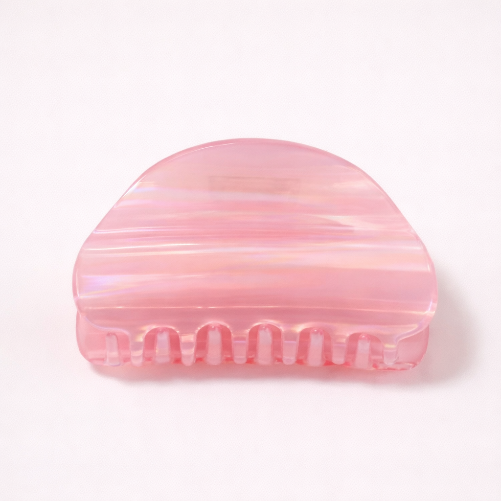 Livvy HAIR CLIP dome-shaped acetate claw clip in an iridescent pink shade, studio shot.