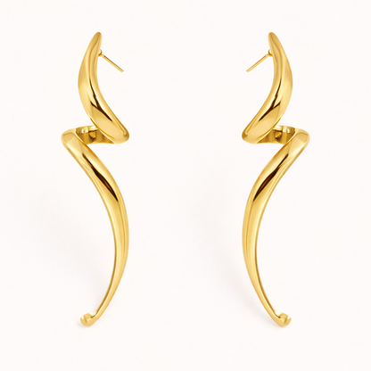Lo Earrings in gold, an elongated sculptural swirl that curves and tapers downward like a slender horn shape.