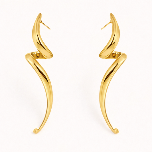 Lo Earrings in gold, an elongated sculptural swirl that curves and tapers downward like a slender horn shape.