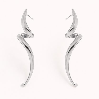 Lo Earrings in polished silver, showing the same elongated swirl design curving into a tapered point.