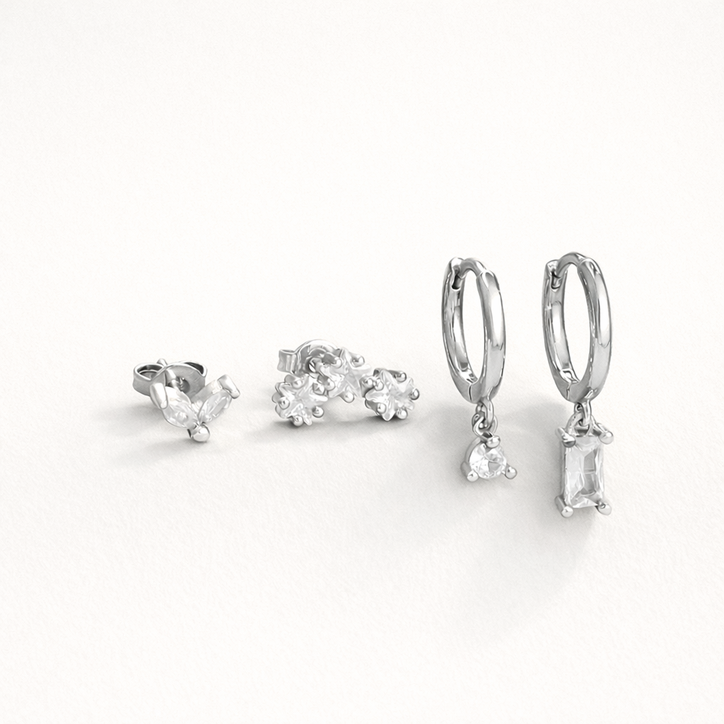 Lola Set in silver tone, showing the same marquise stud, flower-cluster stud, and crystal-drop hoop pair.