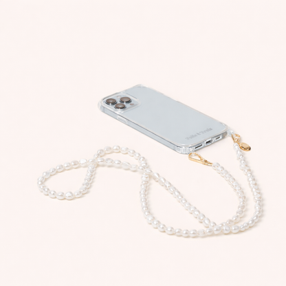 Clear phone case attached to a long strand of small round pearls, the Long Pearl PHONE STRAP shown on a cream background.