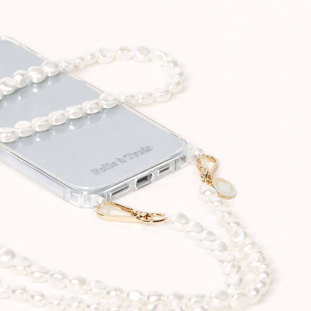Close-up of a phone case attached to a baroque pearl strand with gold-tone clasps, chunkier than the usual round Long Pearl beads.