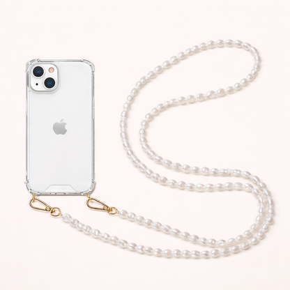 Small round pearl Long Pearl PHONE STRAP attached to a clear phone case, shown coiled on a cream background.