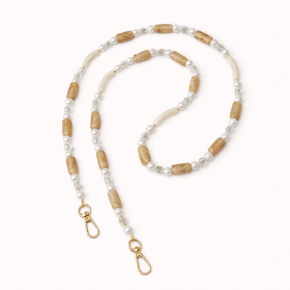 Tan and cream beaded Loreto phone strap coiled flat, finished with pearl and crystal accents.