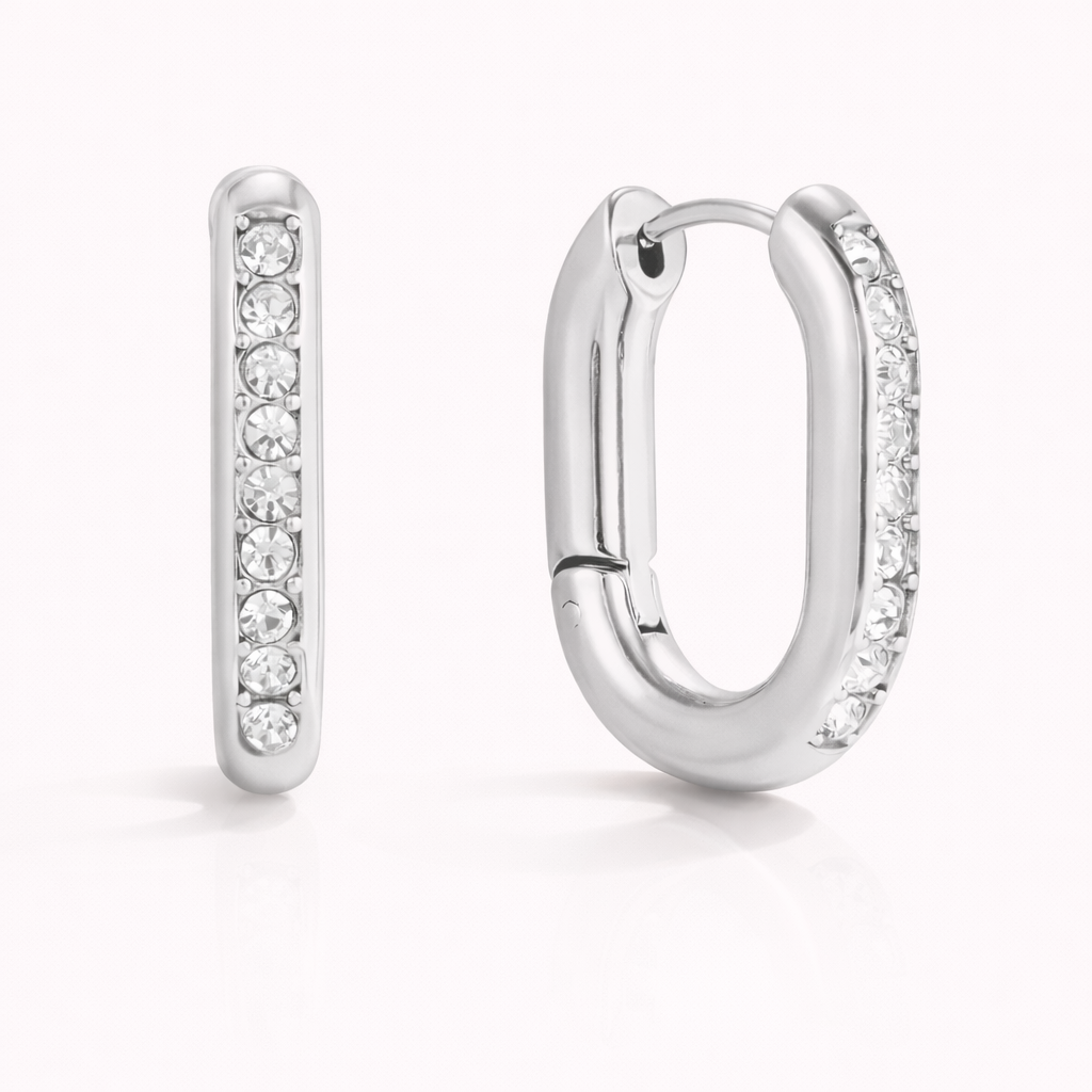 The Love Bite EARRINGS are shown in silver, with chunky rectangular hoops fully lined with crystals.