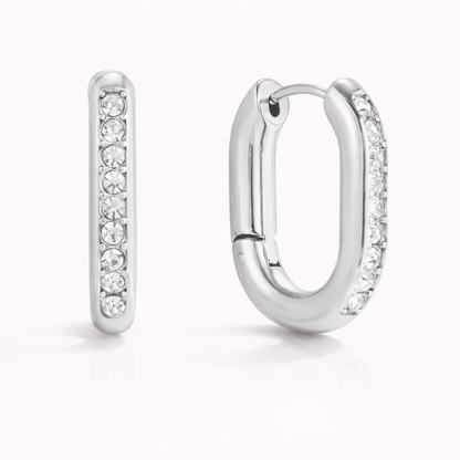 The Love Bite EARRINGS are shown in silver, with chunky rectangular hoops fully lined with crystals.