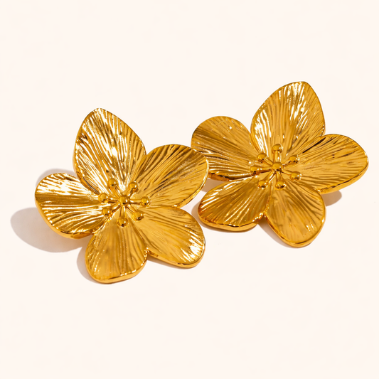 Love Language Earrings form large sculptural gold flowers with ridged, textured petals and a raised center.