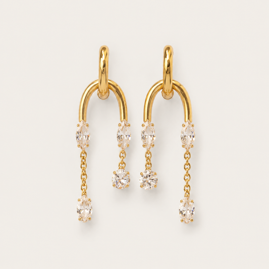 Gold arched drop earring with marquise and round white zirconia stones cascading in a delicate line — Folie à Trois Luce EARRINGS.