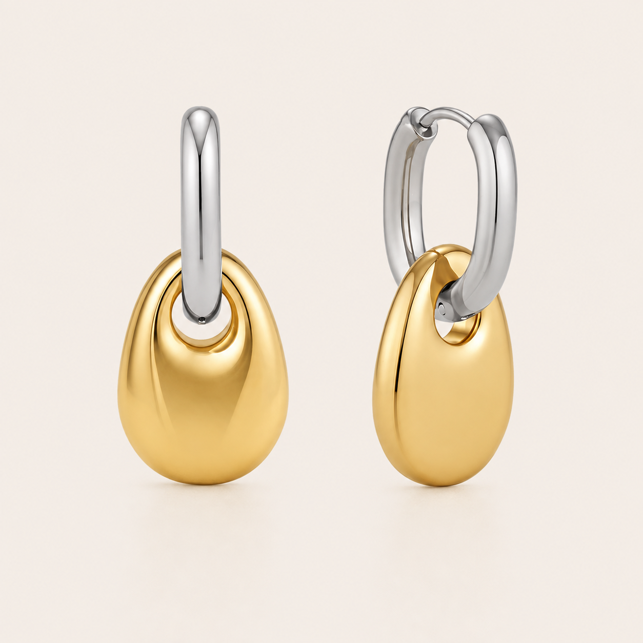 Two-tone gold and silver pebble-drop hoop earring with a glossy rounded teardrop dangling from the hoop — Folie à Trois Lucent EARRINGS.