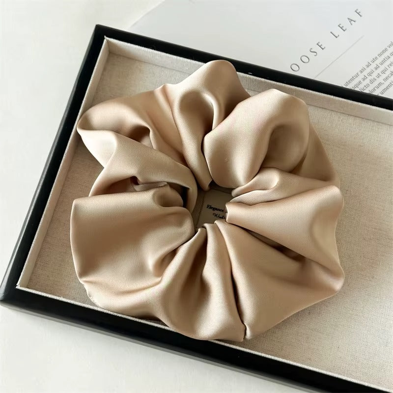 Lucia SCRUNCHIE XL oversized satin scrunchie in taupe, shown in a black gift box.