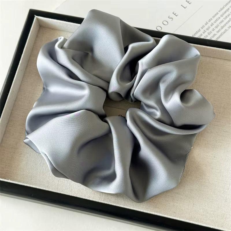 Lucia SCRUNCHIE XL oversized satin scrunchie in grey, shown in a black gift box.