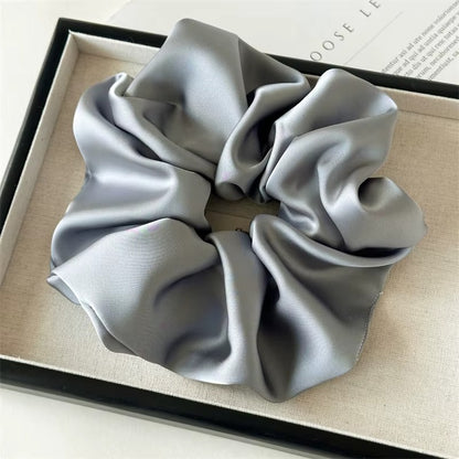 Lucia SCRUNCHIE XL oversized satin scrunchie in grey, shown in a black gift box.