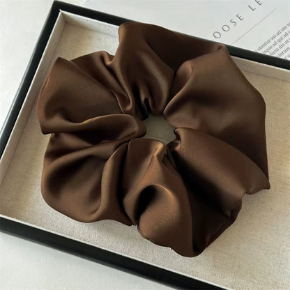Lucia SCRUNCHIE XL oversized satin scrunchie in dark brown, shown in a black gift box.