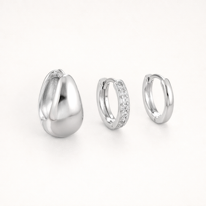 Lulu Set in silver tone, a chunky teardrop hoop, a pave hoop, and a plain hoop, shown together from an angle.